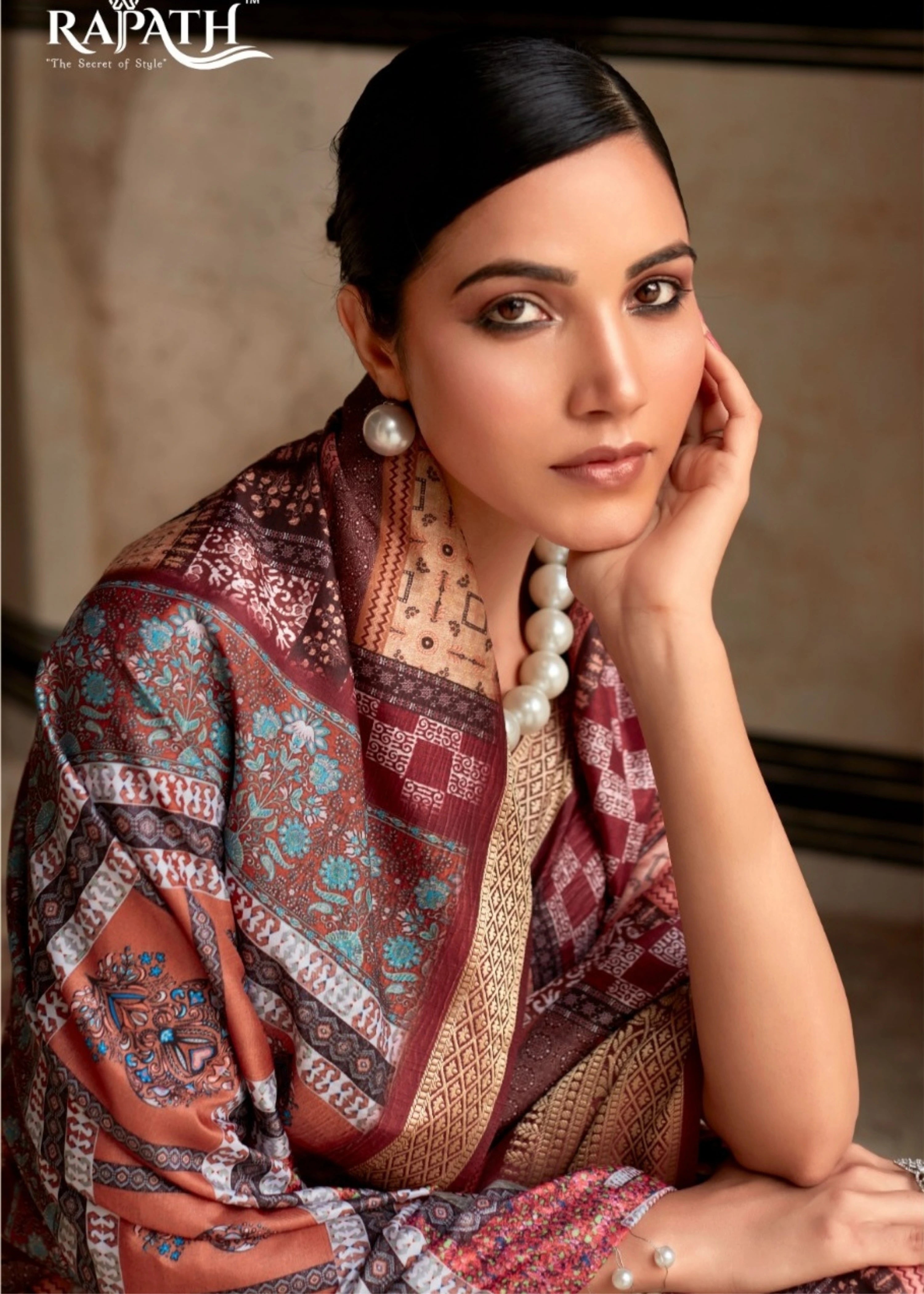 Woman wearing a patterned shawl with 'Rapath' branding in the corner.
