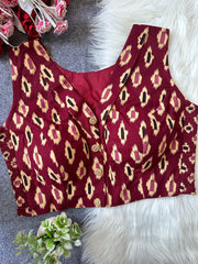 Red leopard print top on a textured surface with flowers and greenery.