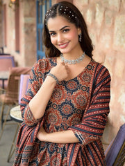 Woman wearing a patterned dress with jewelry indoors