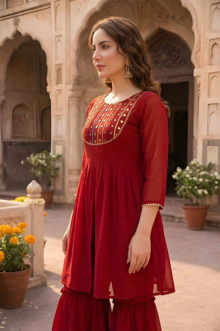Woman in a red traditional outfit standing in front of architectural background