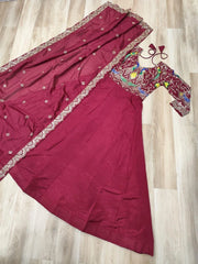 Maroon saree with embroidered blouse on a wooden floor