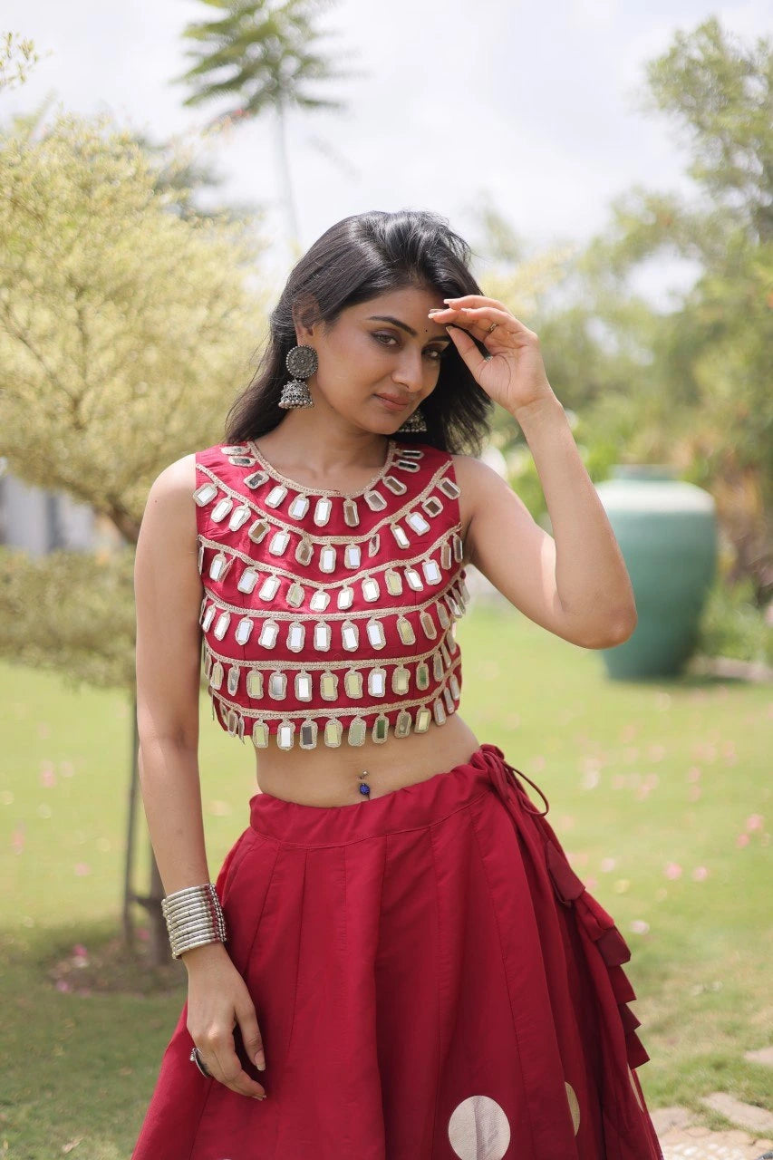 Stunning pink lehenga with oversized gold foil polka dots and a heavily embellished mirror work blouse for a luxurious festive appearance.