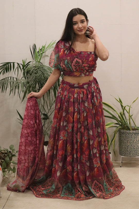 Woman wearing a patterned outfit with plants in the background