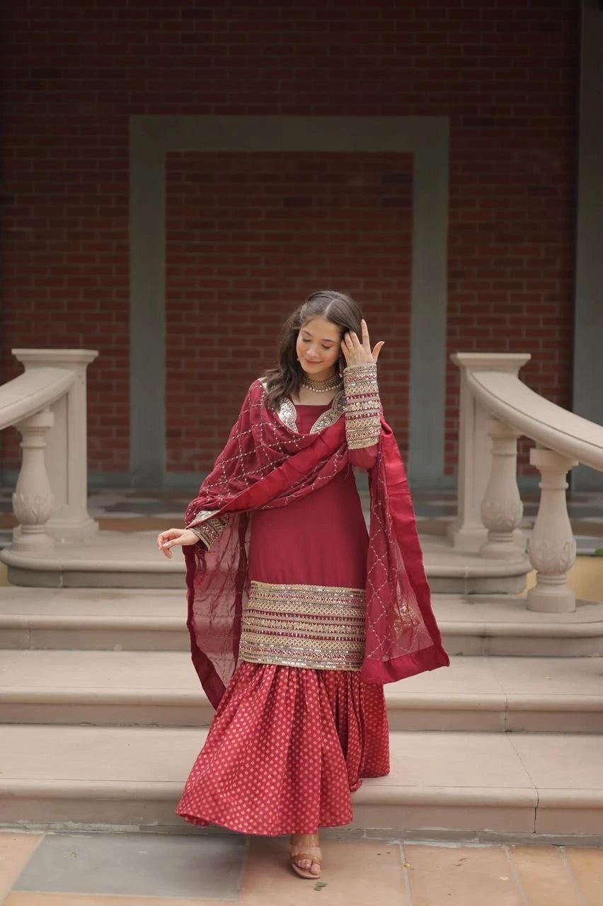 Woman in a red traditional outfit standing on steps with a brick wall background