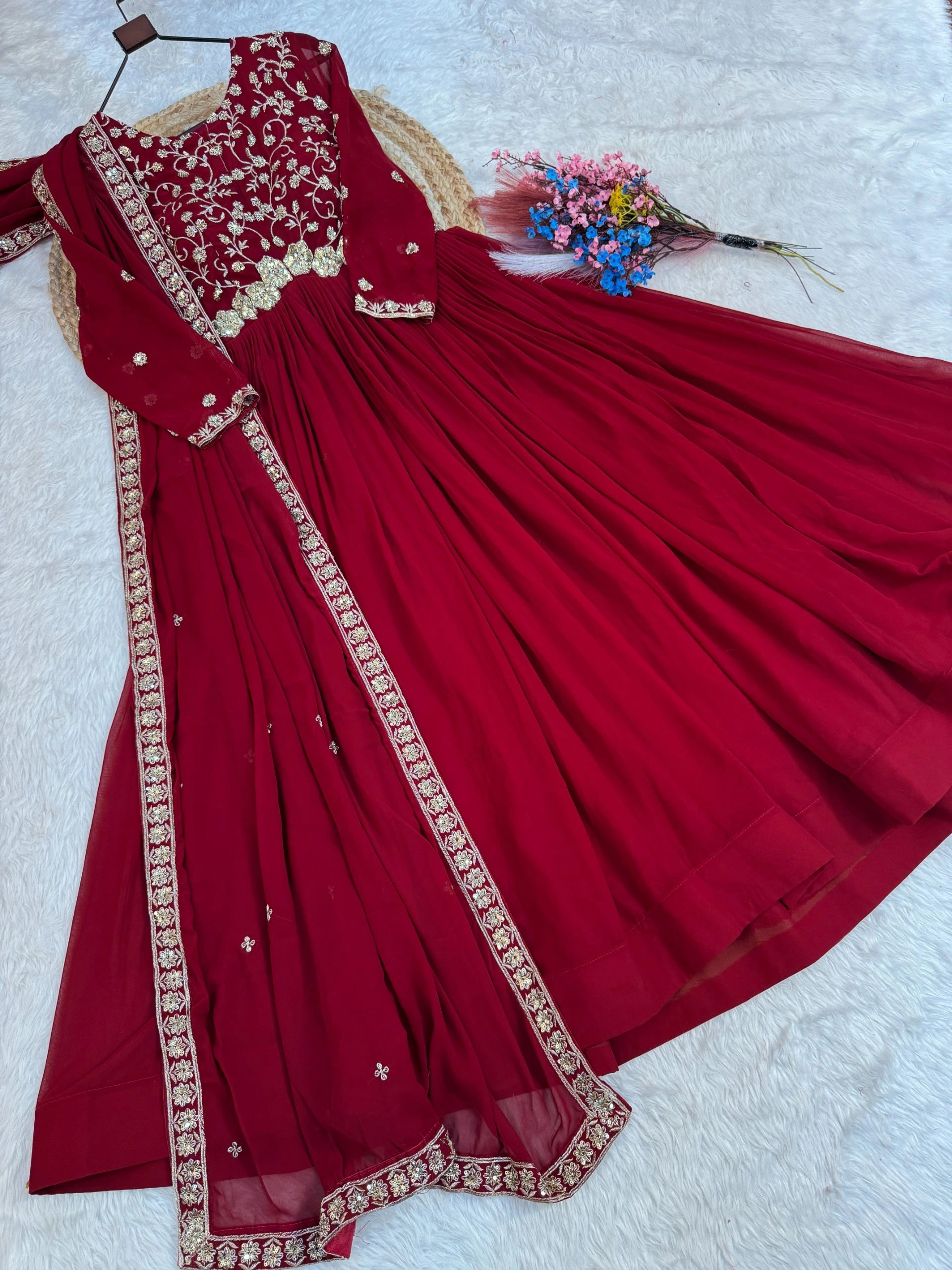 Red traditional outfit with gold embroidery on a white background