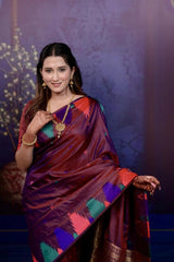 Woman wearing a colorful saree with a decorative background