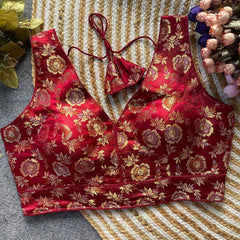 Red floral-patterned top on a textured surface with decorative elements.