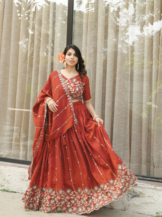 Woman in a red traditional outfit with floral decorations against a neutral background