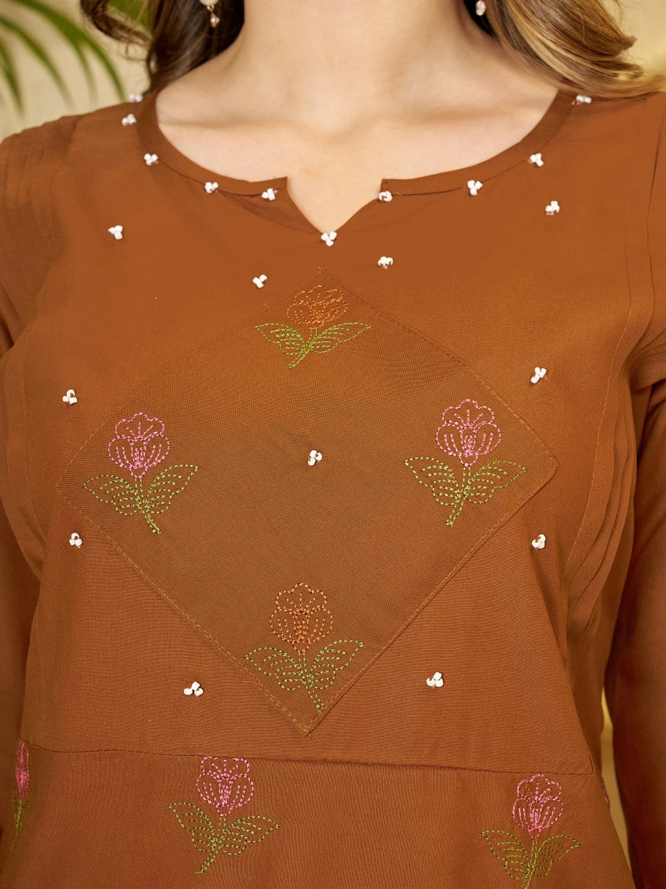 Brown top with floral embroidery and bead details