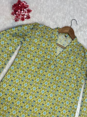 Floral patterned shirt on a hanger with a wooden hook against a textured white background