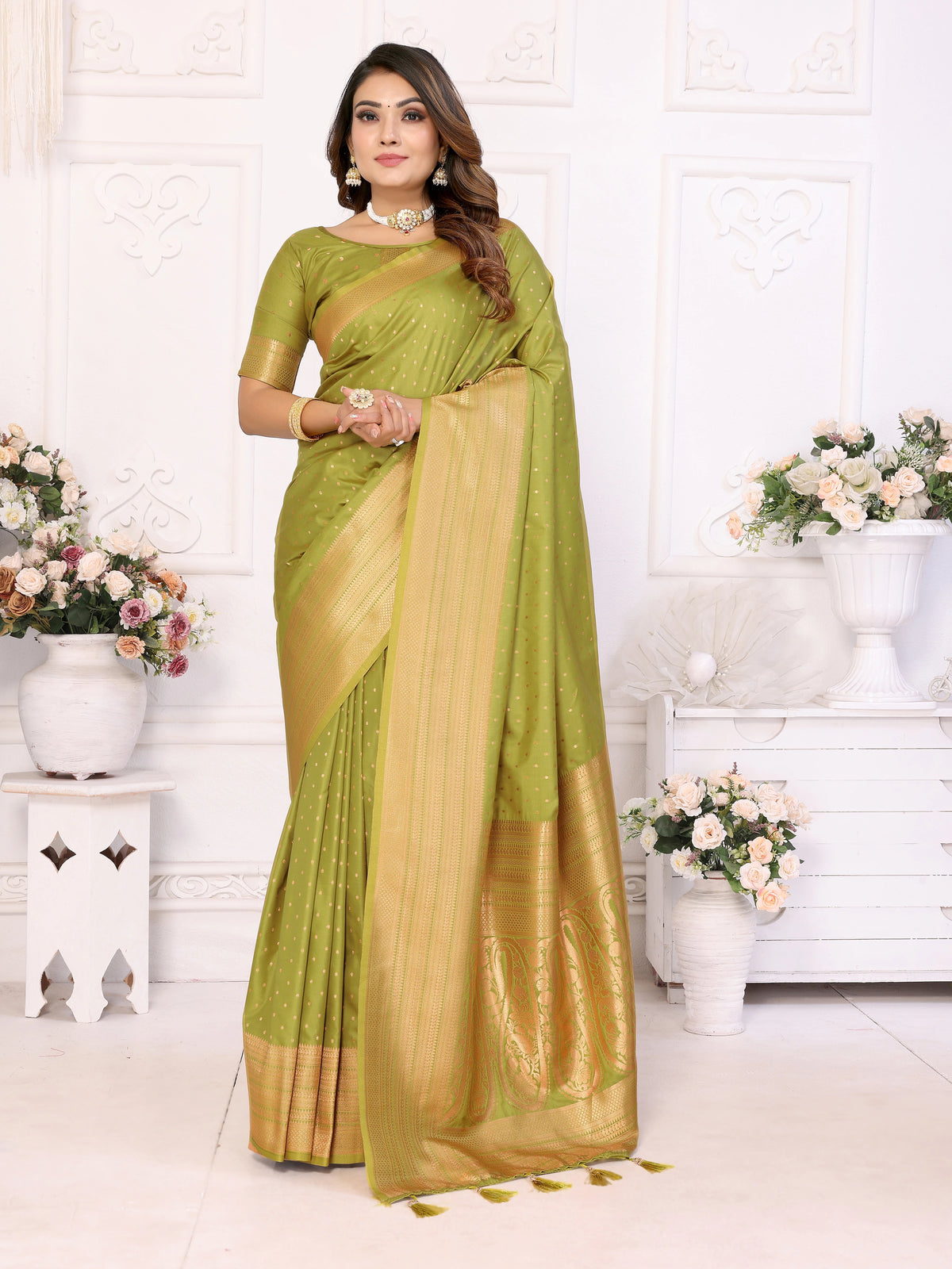 Woman wearing a green saree with a white background