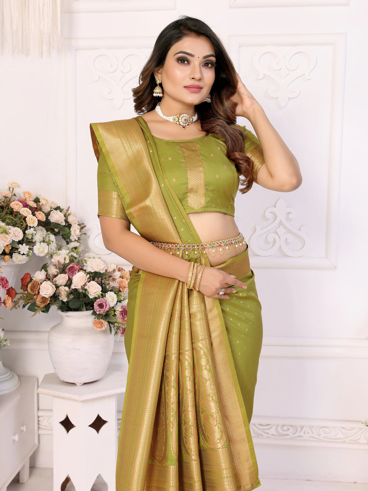 Woman wearing a green saree with a white background