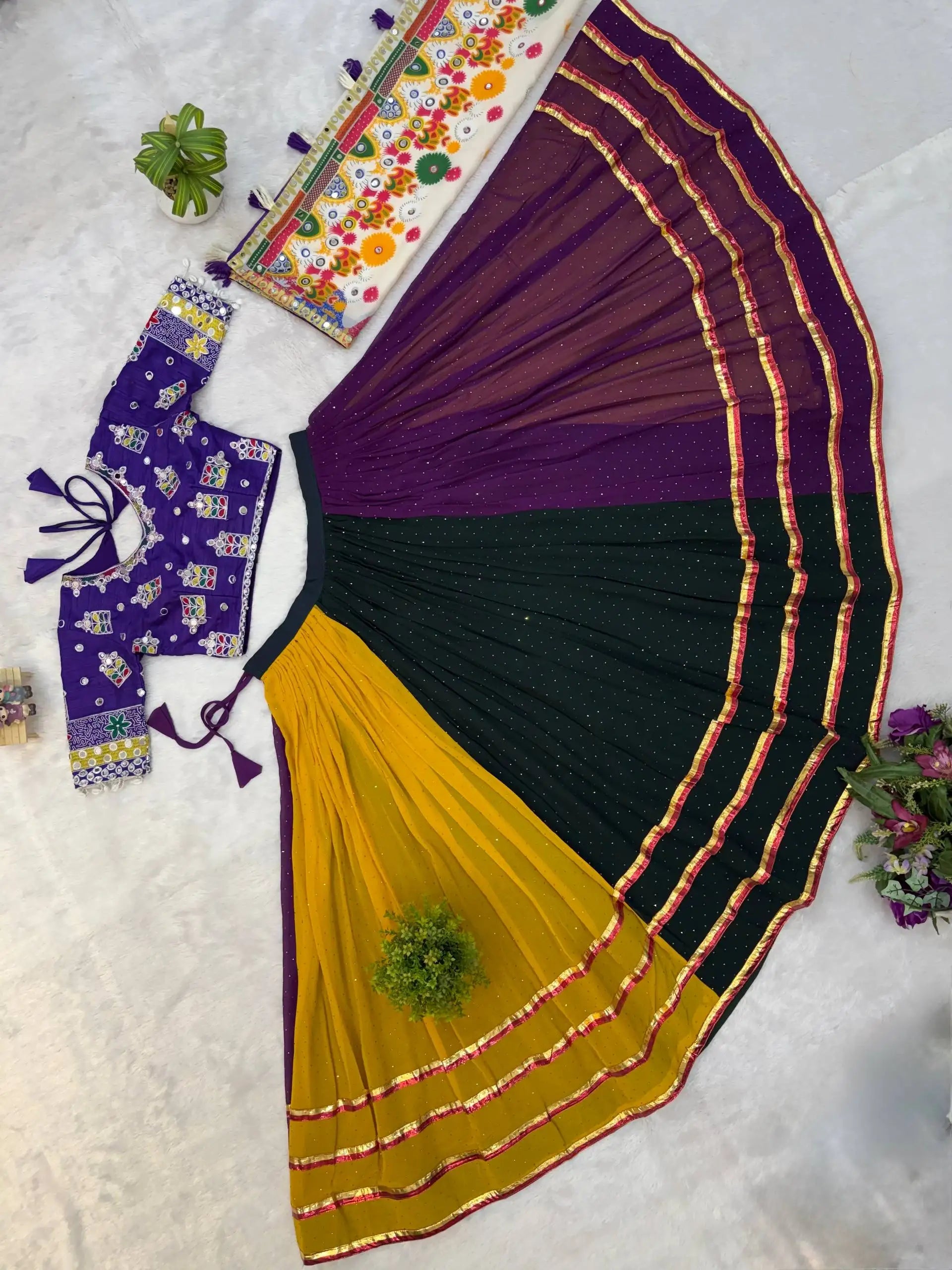 Top-down flat lay of multicolor lehenga full spread showing three panels and choli with dupatta