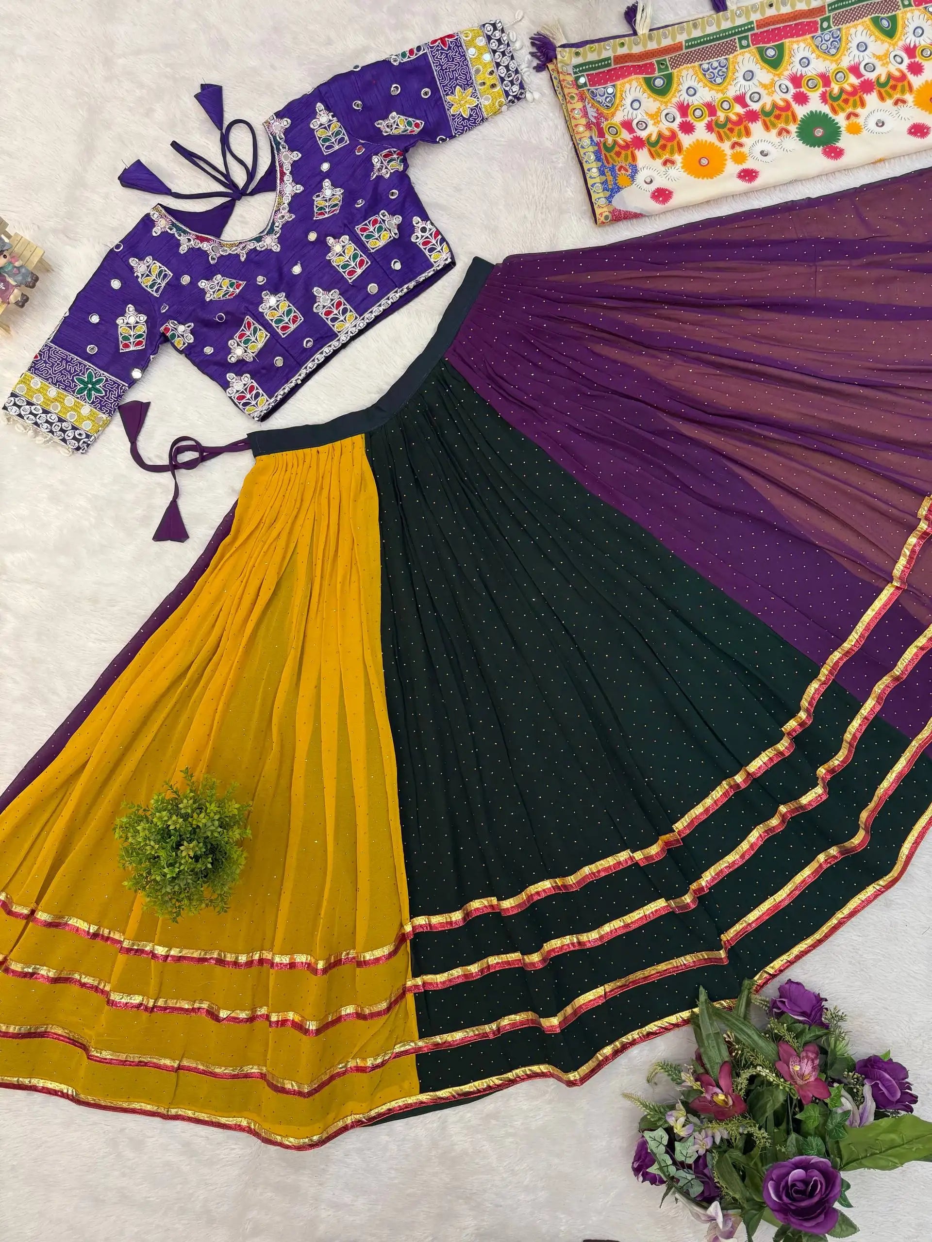Flat lay of full multicolor hot fix lehenga set with purple choli, three-panel skirt and Kutchi dupatta