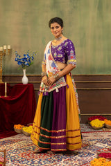 Front standing view of multicolor hot fix diamond lehenga with Kutchi dupatta held in hands