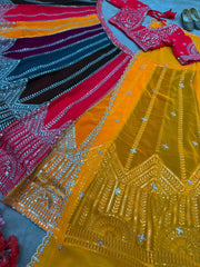 Flat lay of full multicolor lehenga set showing panelled skirt with geometric hem zari embroidery