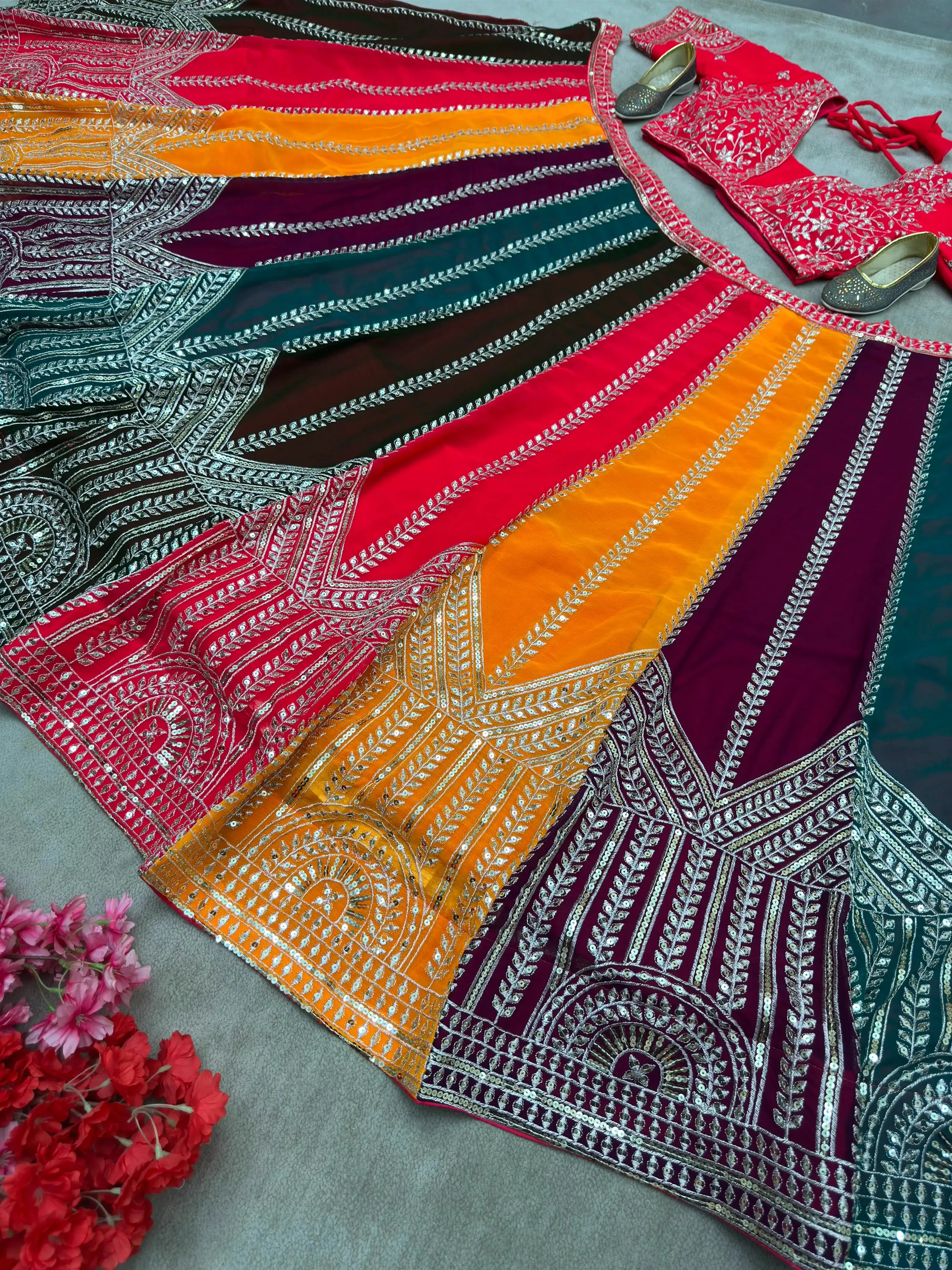 Close-up of multicolor lehenga border with intricate arch motif zari and sequins embroidery