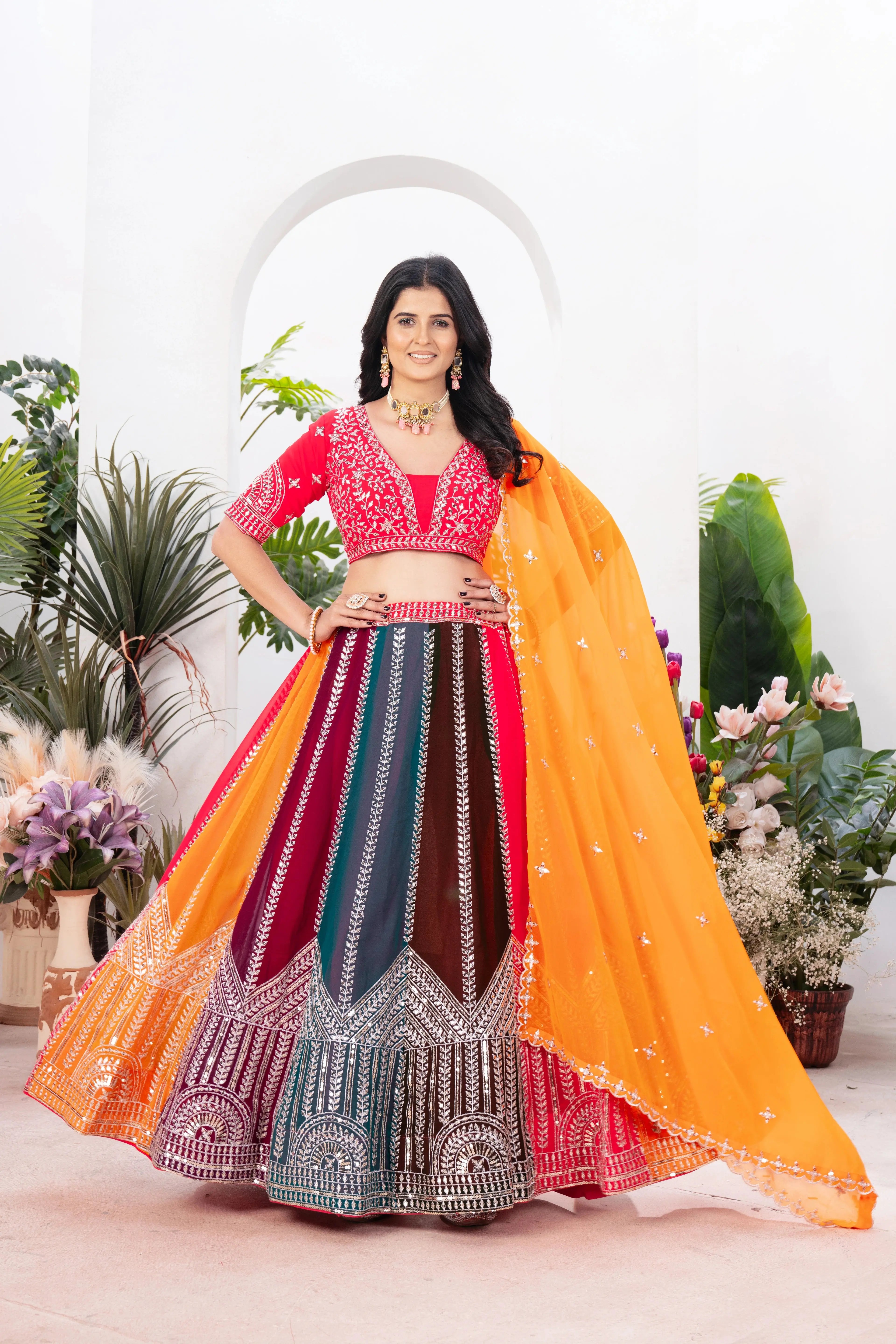 Multicolor circular panelled lehenga in red, orange, teal and maroon with silver zari embroidery
