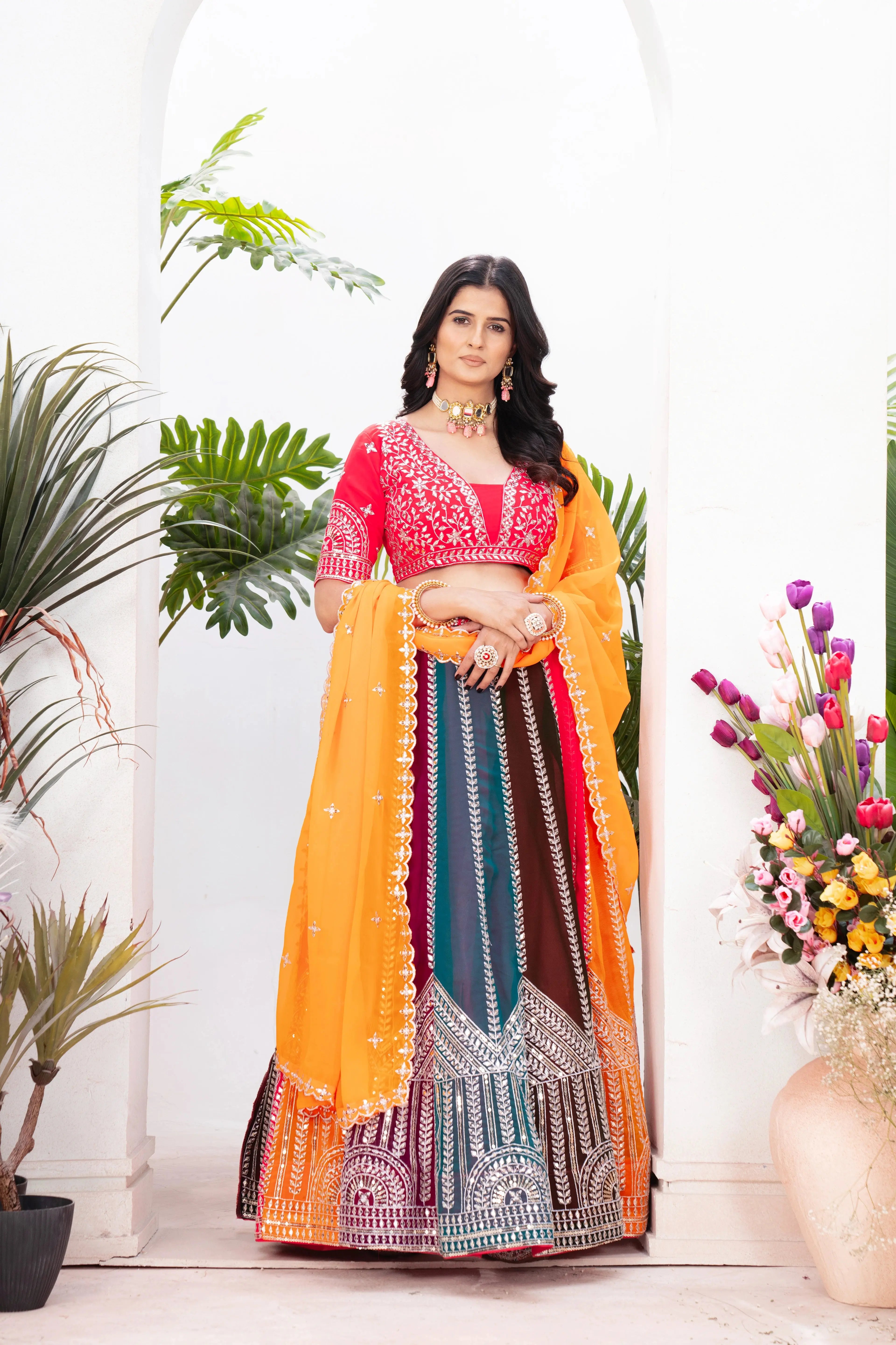 Full length view of multicolor zari embroidered lehenga with heavy hem embroidery and orange dupatta