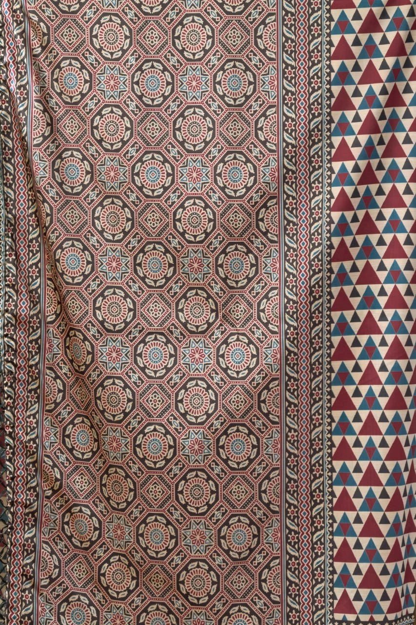 Patterned fabric with geometric designs in red, blue, and brown.