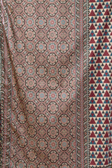Patterned fabric with geometric designs in red, blue, and brown.