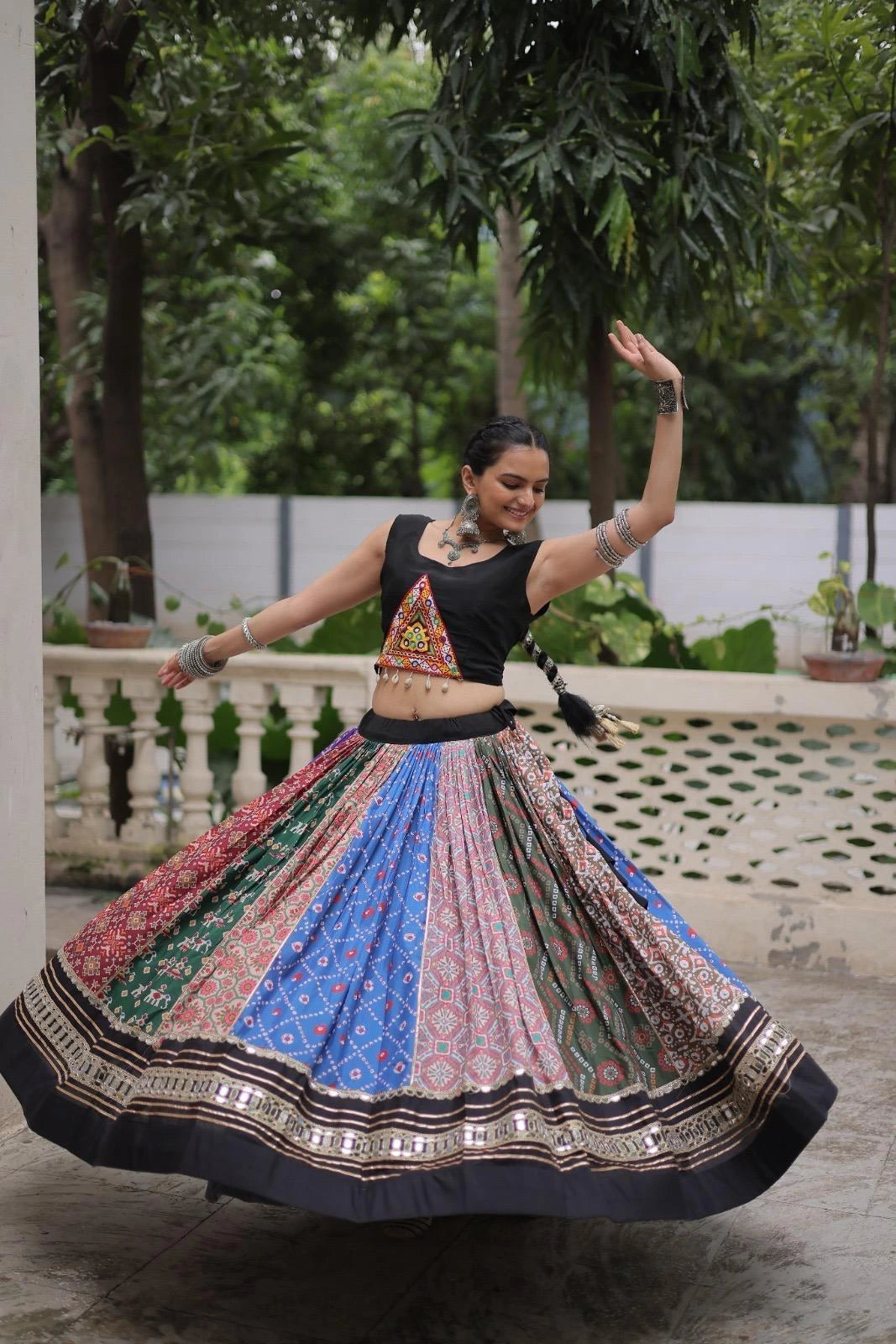 Elegant multicolor cotton lehenga highlighted with shimmering gota patti and mirror lace embellishments.