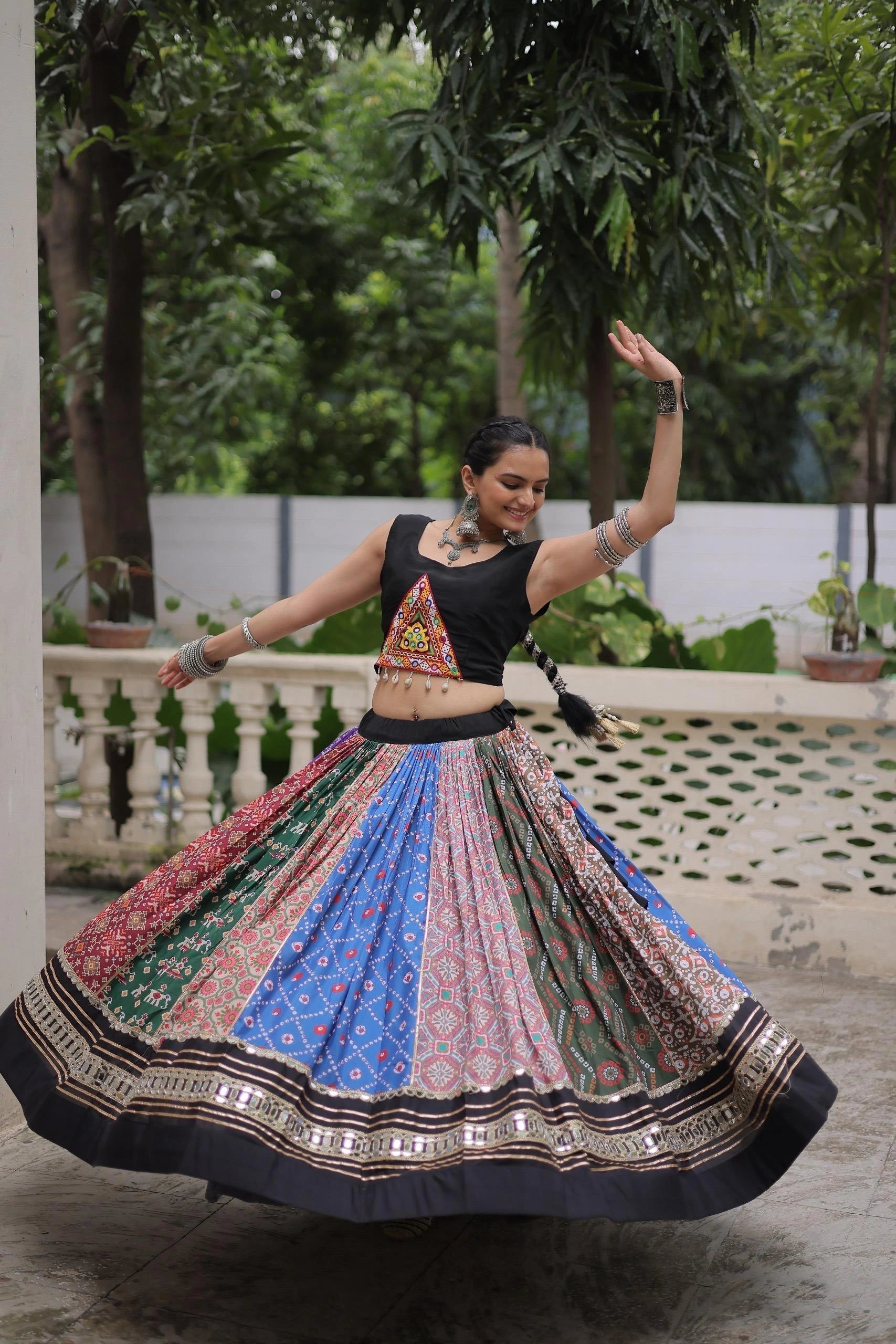 Detailed view of multicolor digital print cotton lehenga with handcrafted mirror lace and gota patti design.