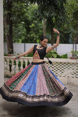 Detailed view of multicolor digital print cotton lehenga with handcrafted mirror lace and gota patti design.