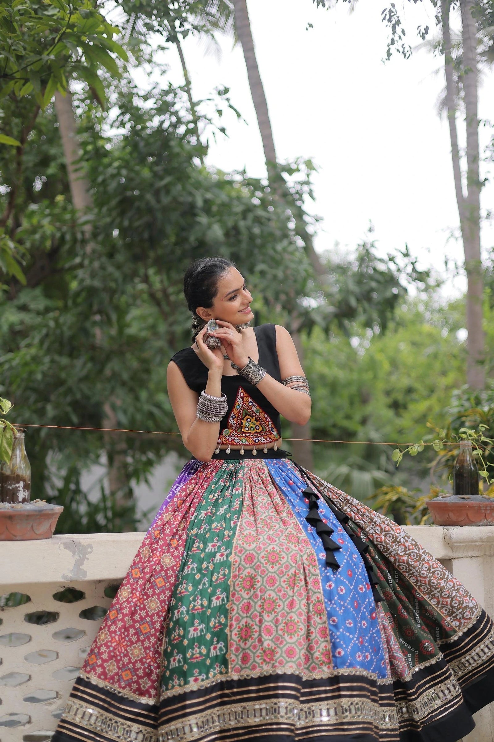 Designer multicolor cotton lehenga adorned with digital prints, mirror lace borders, and gota patti embroidery.
