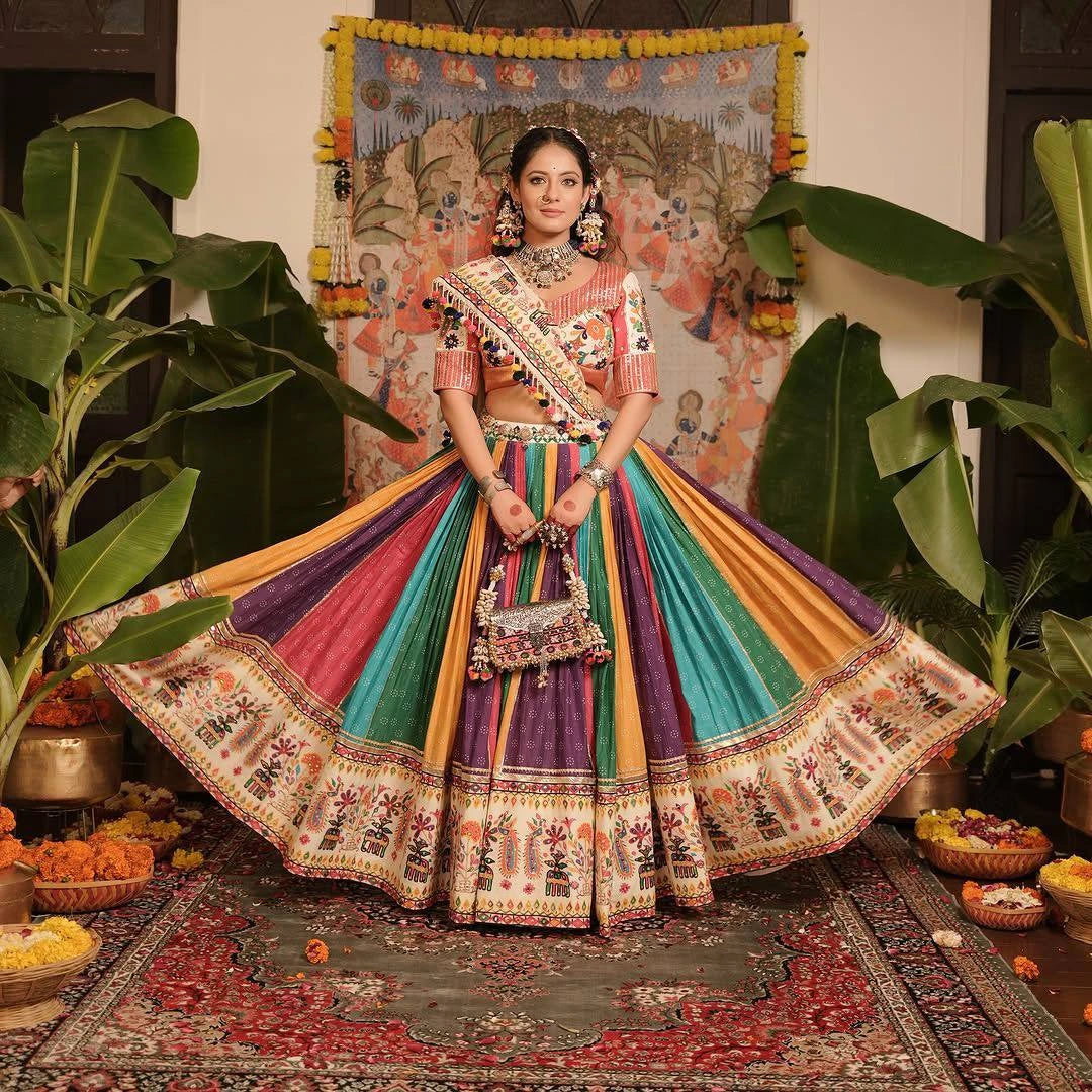 Woman in a colorful traditional outfit standing in a decorated room with plants and decorative items.
