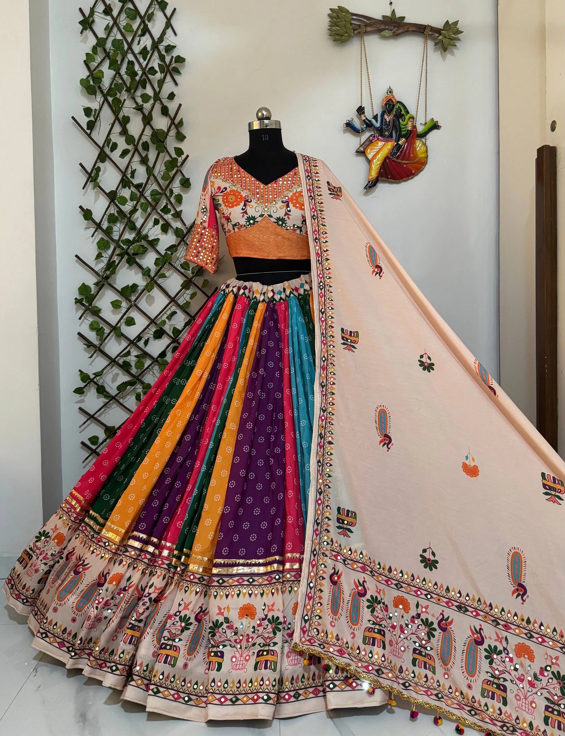 Colorful traditional outfit with a mannequin against a neutral wall.