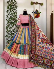 Colorful traditional outfit with a mannequin against a decorative wall.