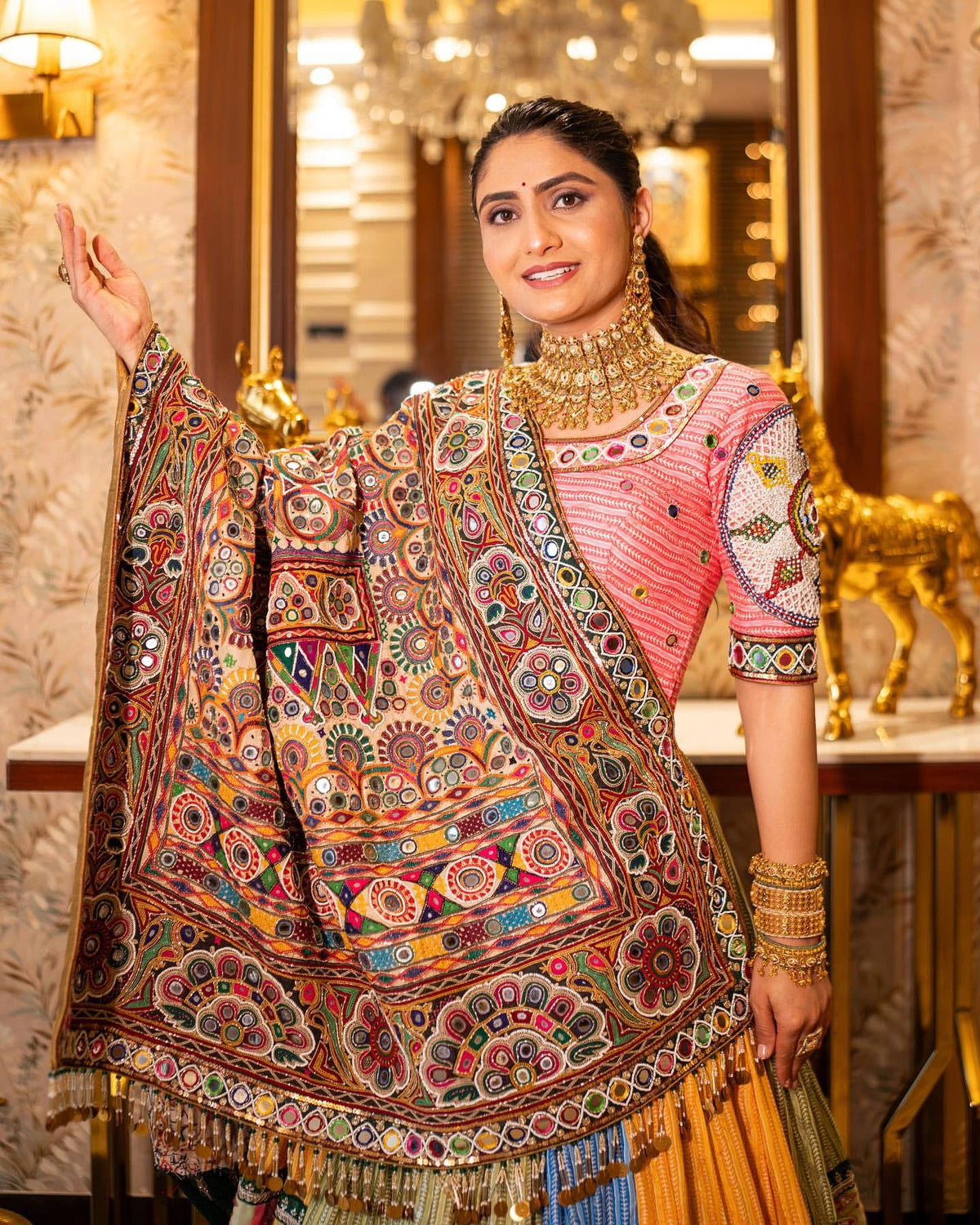 Woman wearing a traditional embroidered saree in an elegant interior setting
