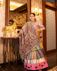 Woman in traditional multicolored outfit standing in a decorated room with decorative elements.