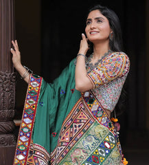 Woman wearing a colorful traditional outfit with a green background