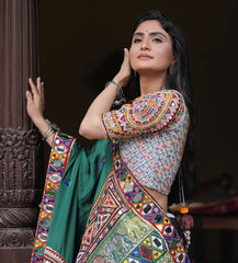 Woman wearing a colorful traditional outfit with a dark background
