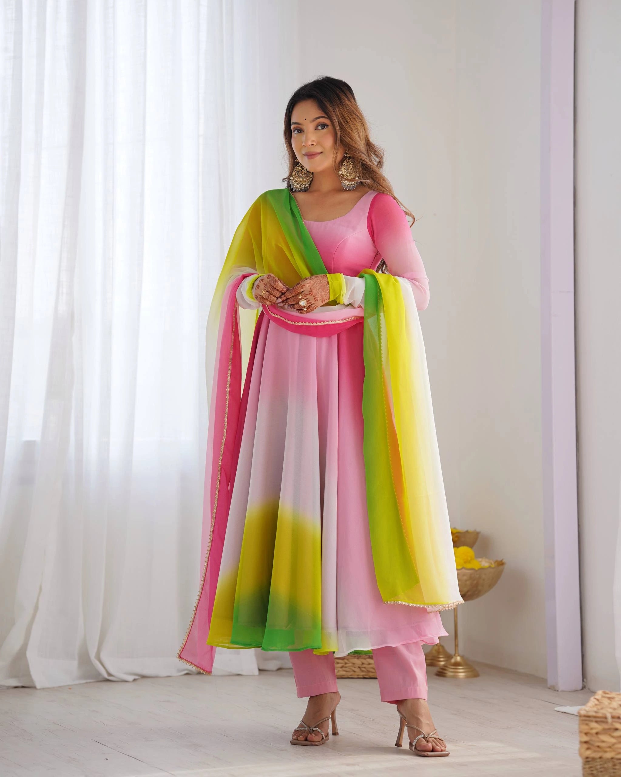 Pink faux georgette suit with floral zari work, full sleeves, round neck, paired with matching pant and dupatta.