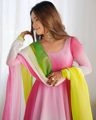 Woman wearing a pink and yellow traditional outfit with a white background