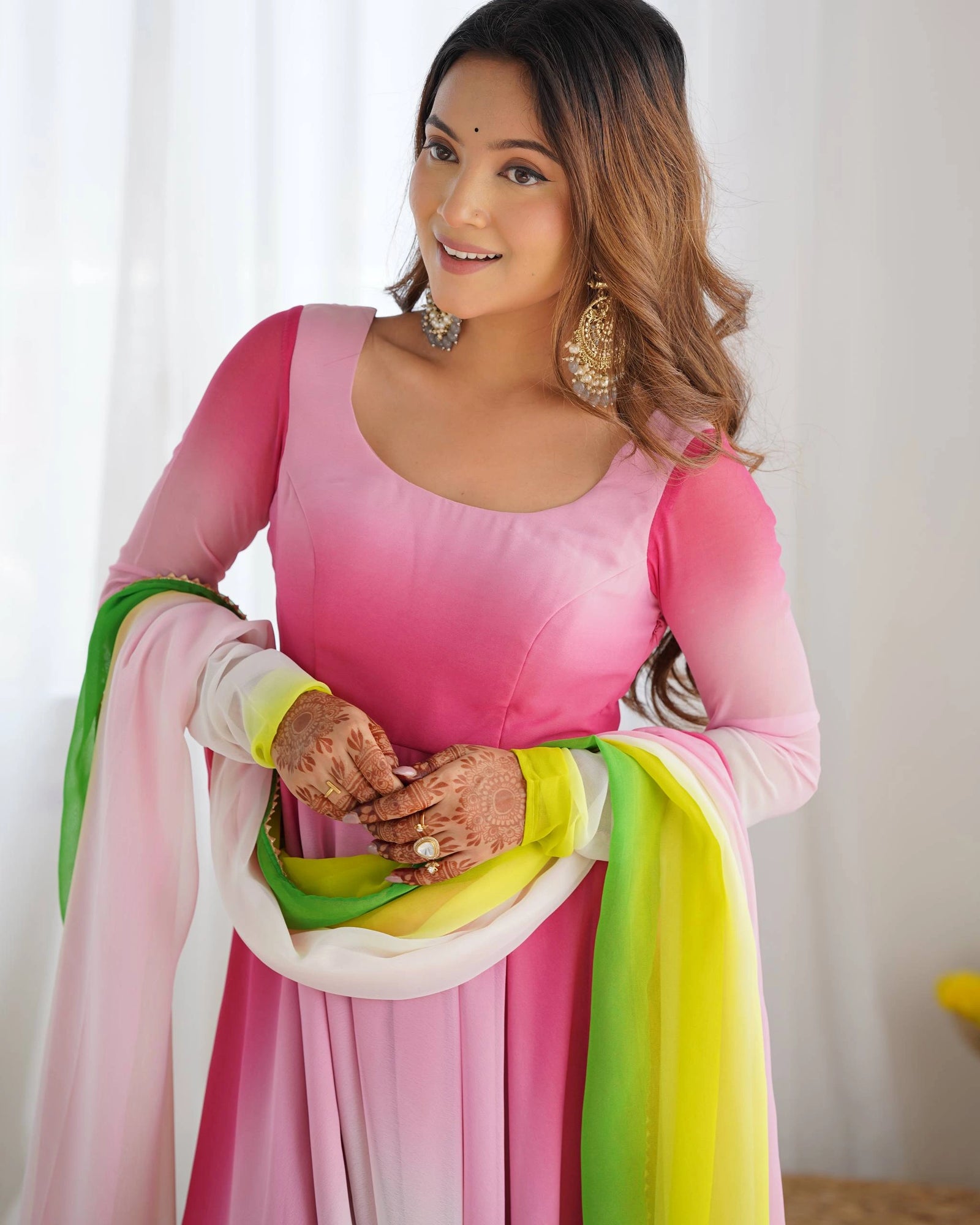 Light pink georgette party suit with intricate floral zari motifs, long sleeves, round neck, paired pant and sheer dupatta.