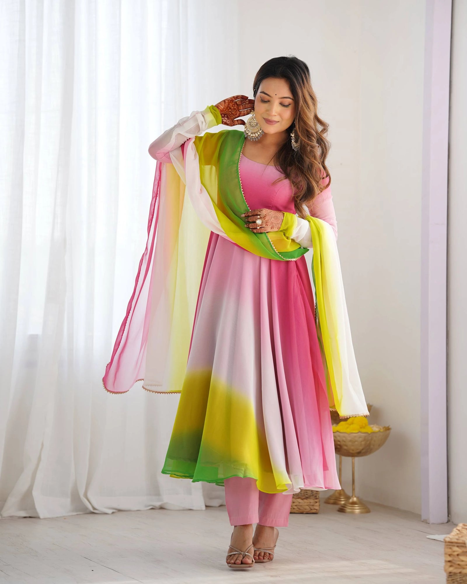 Graceful pink faux georgette suit with floral zari detailing, round neck, long sleeves, and matching pant with dupatta.