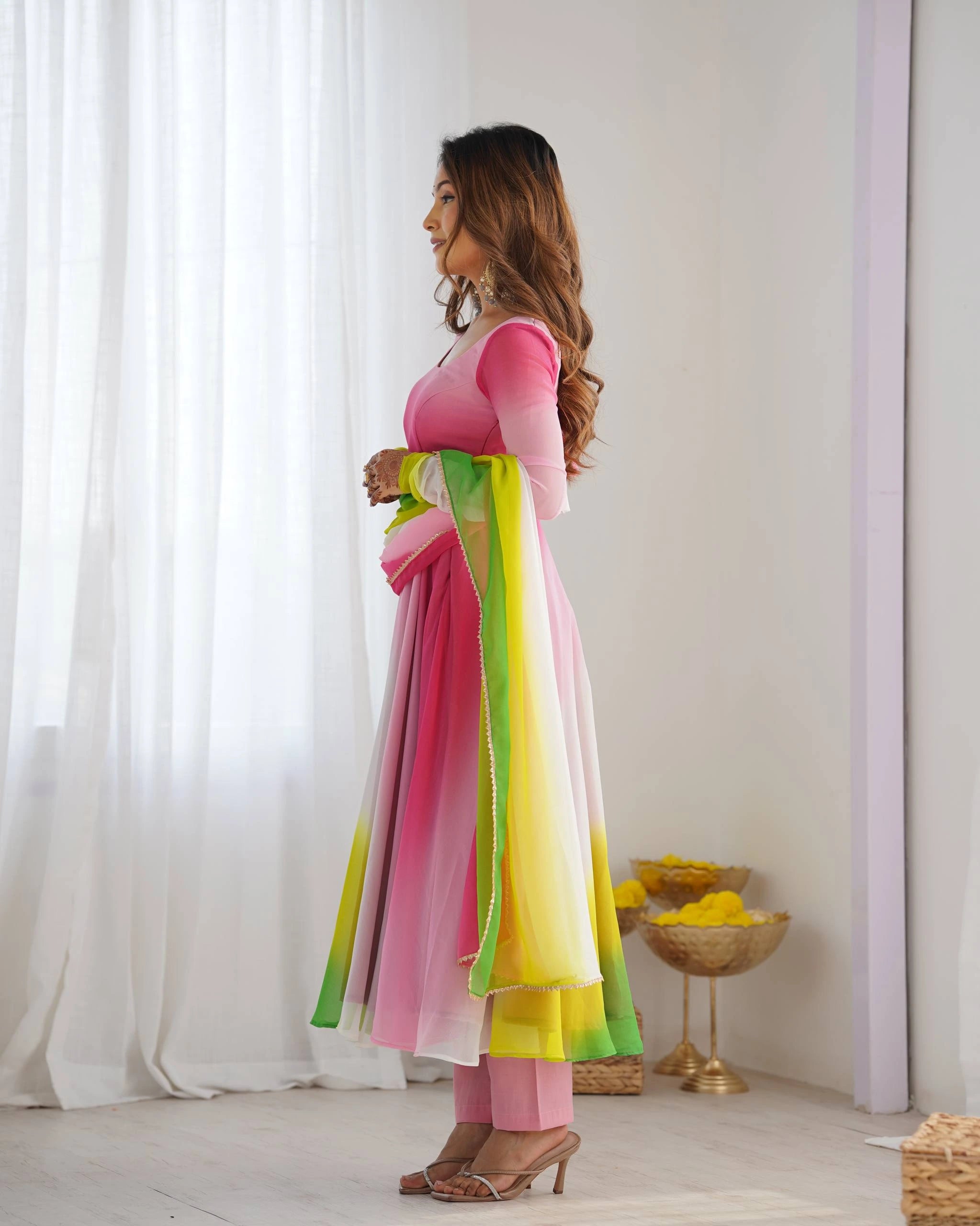 Stylish pink faux georgette suit with floral zari accents, round neckline, long sleeves, and coordinated pant with dupatta.