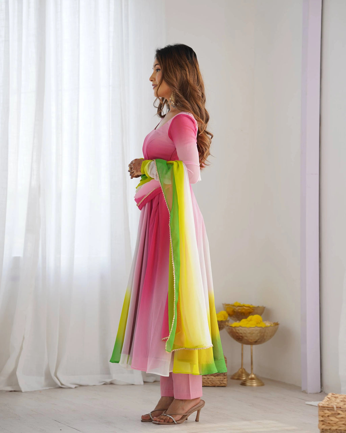 Stylish pink faux georgette suit with floral zari accents, round neckline, long sleeves, and coordinated pant with dupatta.