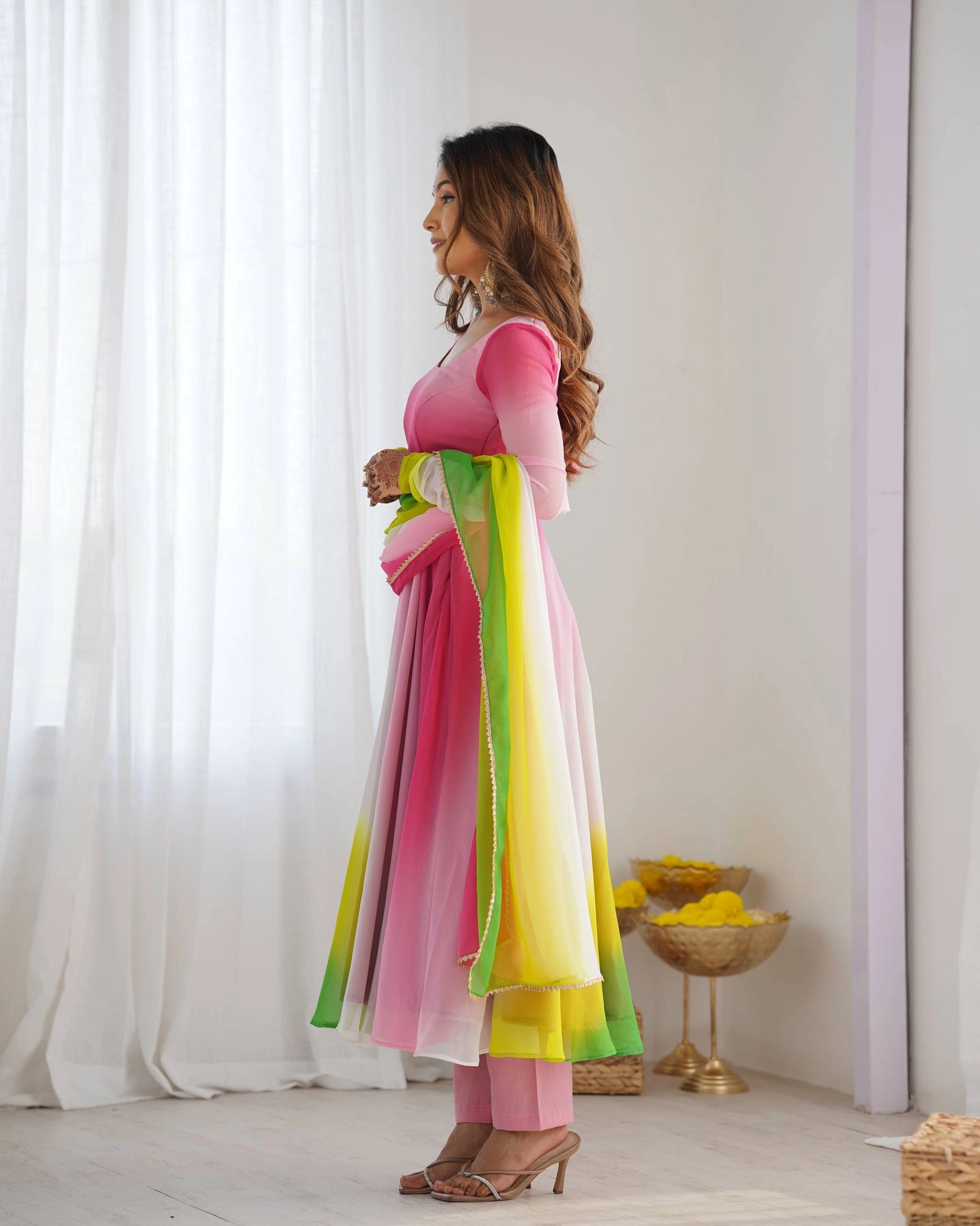 Stylish pink faux georgette suit with floral zari accents, round neckline, long sleeves, and coordinated pant with dupatta.