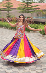 Woman in a colorful traditional outfit dancing outdoors.