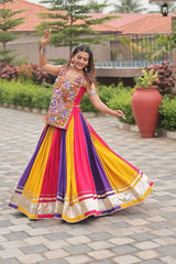 Woman in a colorful traditional outfit dancing outdoors on a paved area.
