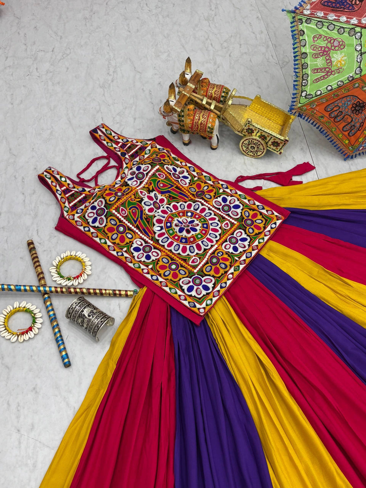 Colorful traditional outfit with intricate patterns on a textured surface