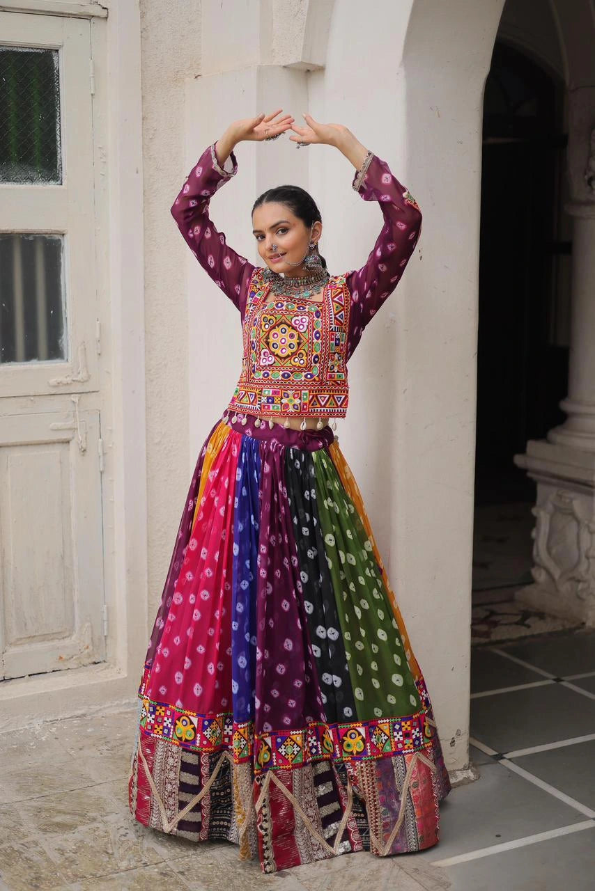 Woman in a colorful traditional outfit posing in an outdoor setting.