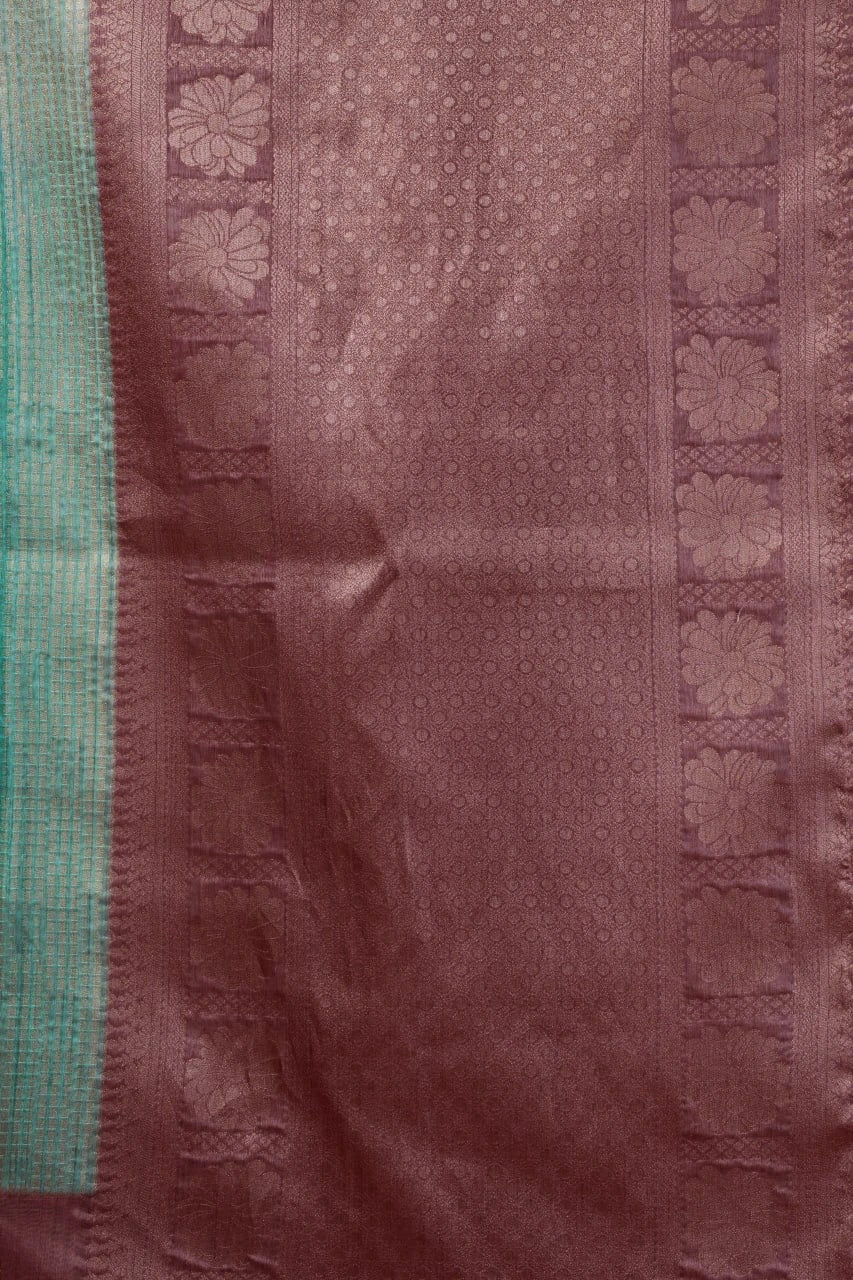 Brown fabric with intricate patterns and a green border