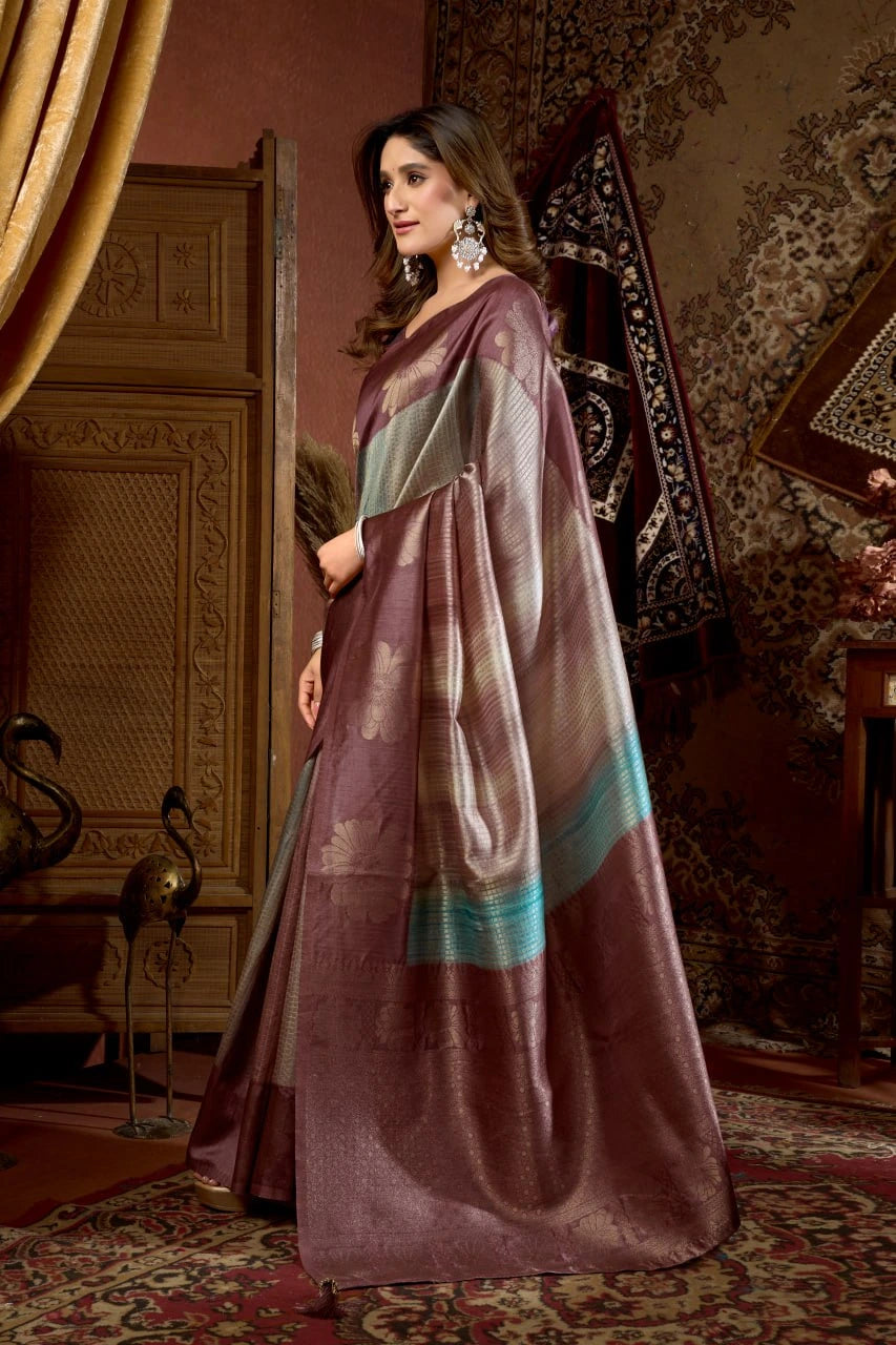 Woman in a traditional saree standing in an ornate room with decorative elements.