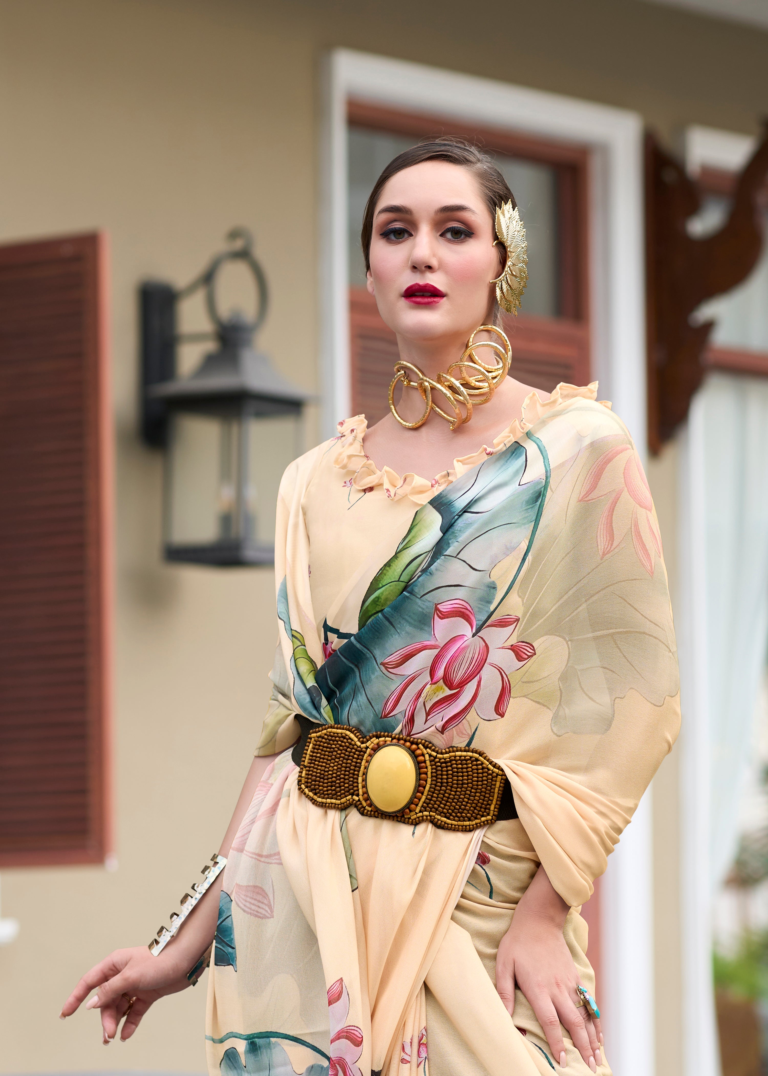 Woman wearing a green saree with floral patterns in an urban setting